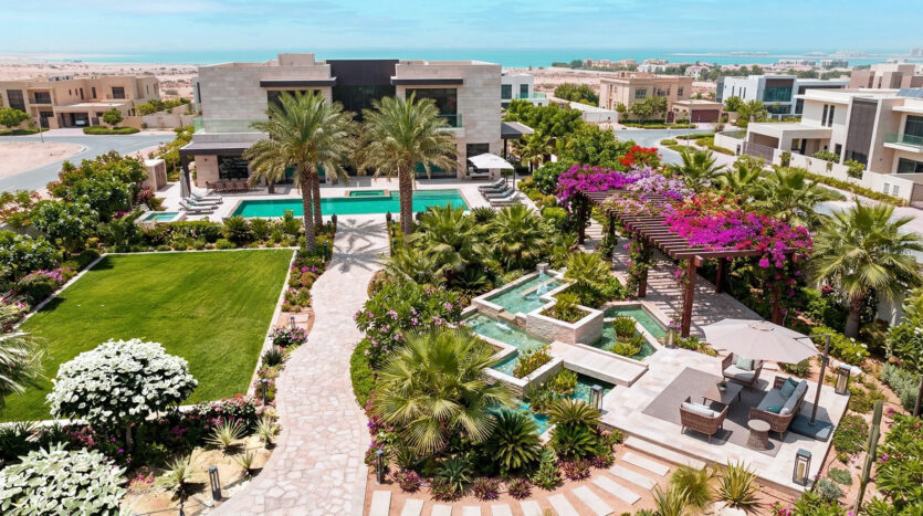 Premium villa community scene with landscaped pathways, wellness gardens, elegant homes, and a calm country club lifestyle atmosphere in Dubai.